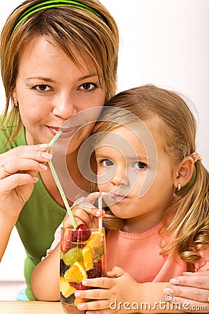 Girls sipping fruity refreshment Stock Photo