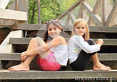 Girls sitting on stairs Stock Photo