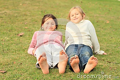 Girls with smileys on toes Stock Photo