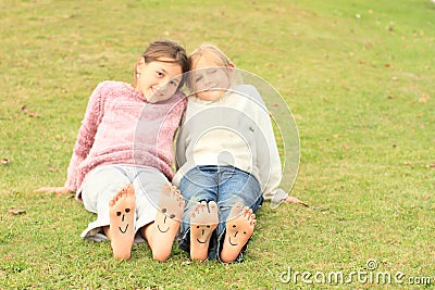 Girls with smileys on toes and soles Stock Photo