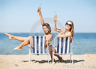 Girls sunbathing on the beach chairs Stock Photo