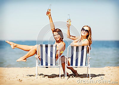 Girls sunbathing on the beach chairs Stock Photo