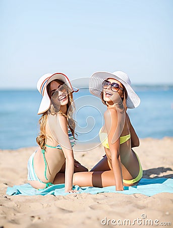 Girls sunbathing on the beach Stock Photo