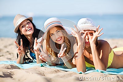 Girls sunbathing on the beach Stock Photo