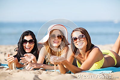 Girls sunbathing on the beach Stock Photo