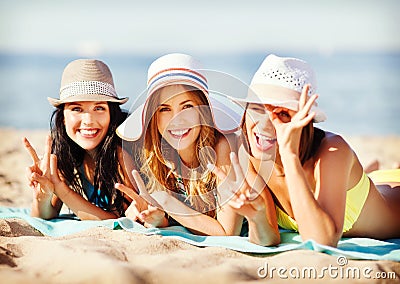 Girls sunbathing on the beach Stock Photo