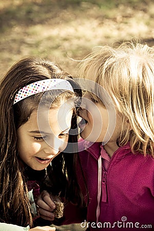 Girls whispering Stock Photo