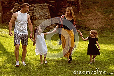 Girls, woman and man smile on summer landscape Stock Photo