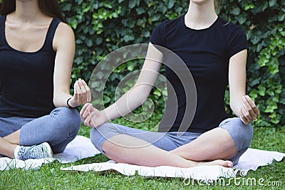 Girls yoga outside park Stock Photo