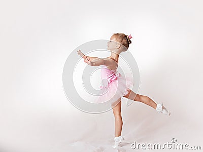 Girls - young ballerinas in pink dresses on a light background Stock Photo