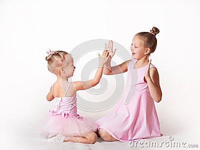 Girls - young ballerinas in pink dresses on a light background Stock Photo