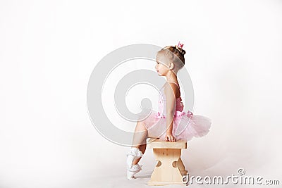 Girls - young ballerinas in pink dresses on a light background Stock Photo