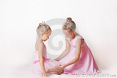 Girls - young ballerinas in pink dresses on a light background Stock Photo