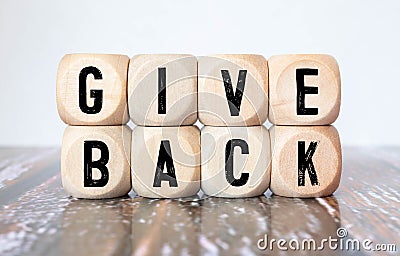 Give Back word written on wood block. Give Back text on table, concept Stock Photo