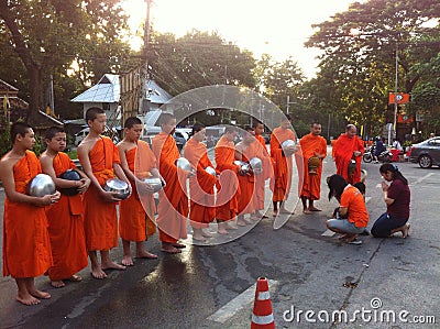 Give food offerings to a Buddhist monk Editorial Stock Photo