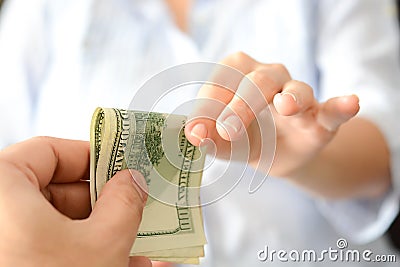 Give money to someone as bribe to suggest a corrupt system Stock Photo