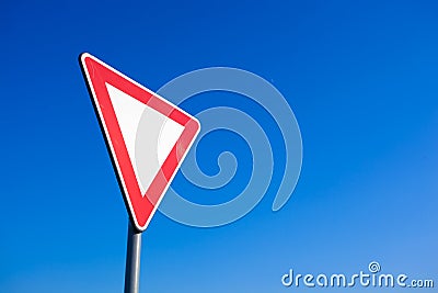 Give precedence signal in the blue sky Stock Photo