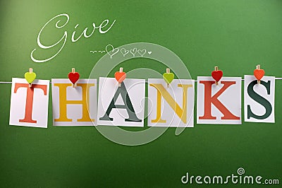 Give Thanks message hanging from pegs on a line for Thanksgiving greeting Stock Photo