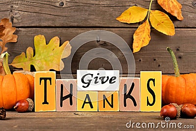 Give Thanks wood sign with pumpkins and leaves Stock Photo