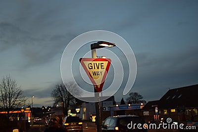 Give way road sign at night Stock Photo