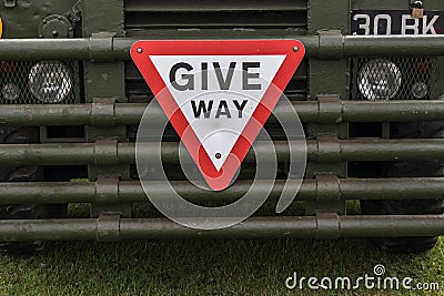 Give Way warning road traffic sugn symbol on the front of a vintage military vehicle truck Editorial Stock Photo