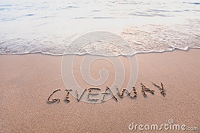 Giveaway concept, word on sand beach Stock Photo