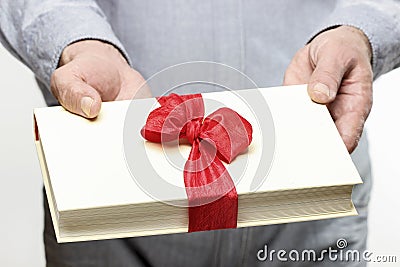 Giving book as a present Stock Photo