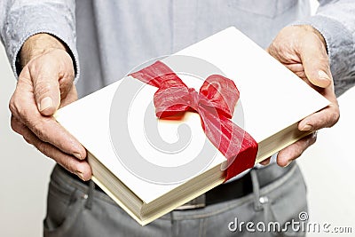 Giving book as a present Stock Photo