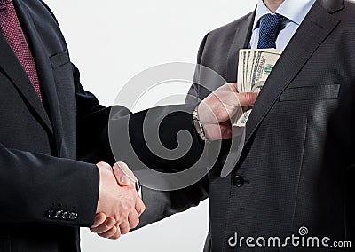 Giving a bribe into a pocket Stock Photo