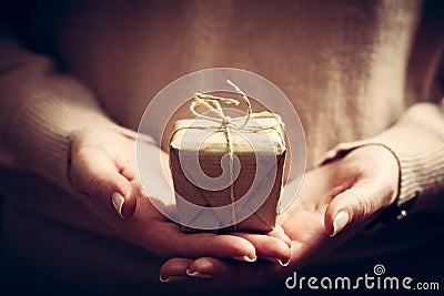 Giving a gift, handmade present wrapped in paper Stock Photo