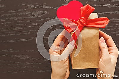 Giving a gift in celebration of Valentine`s day Stock Photo