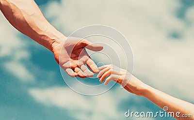 Giving a helping hand. Lending a helping hand. Hands of man and woman reaching to each other, support. Hands of man and Stock Photo