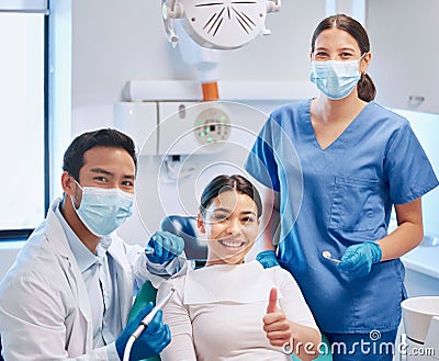 Giving her the permission to smile. a young male dentist giving the thumbs up with his patient and assistant. Stock Photo