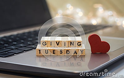 GIVING TUESDAY letter blocks concept on laptop keyboard Stock Photo