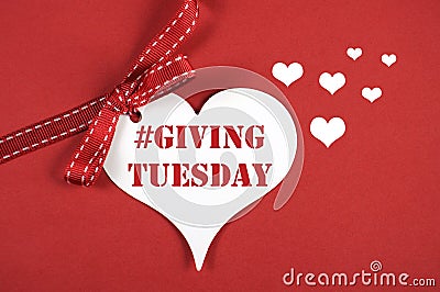 #Giving Tuesday white heart on red background. Stock Photo