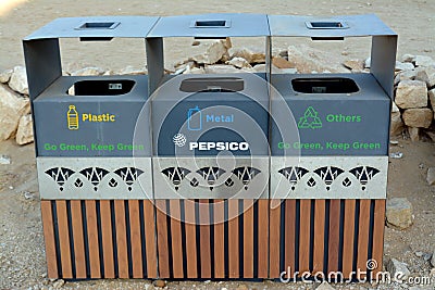 A wooden trash bin for different garbage with an inscription in English (Plastic, metal and Others Editorial Stock Photo