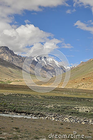 Glacier view in between dry mountains in Darcha-Padum road with clouds in sky during summer Stock Photo