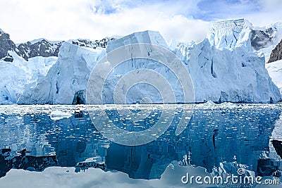 Shelf ice, glacier wall in Antarctica, majestic blue and white glacier edge reflecting in blue sea water, Paradise Bay, Antarctica Stock Photo