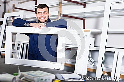 Glad adult labour demonstrating PVC profiles Stock Photo