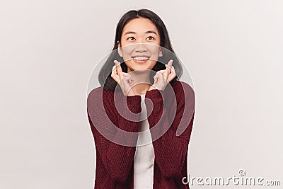 Glad female makes wish smiles gently hopes Stock Photo