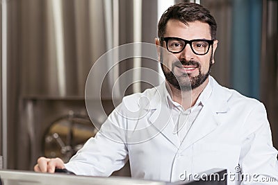 Glad man posing in brewery Stock Photo