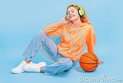 glad redhead basketball woman player on color background. basketball woman player Stock Photo