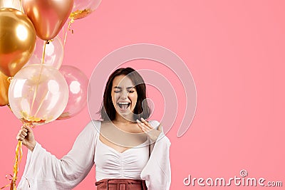 Glad shocked emotional excited young european woman with open mouth holding many inflatable balloons Stock Photo