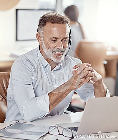 Glad to hear youve had a good experience with us. a mature man using a headset and laptop in a modern office. Stock Photo