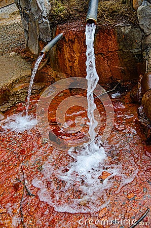 Glade of Narzans. Natural source of mineral sparkling water with a rusty bottom Stock Photo