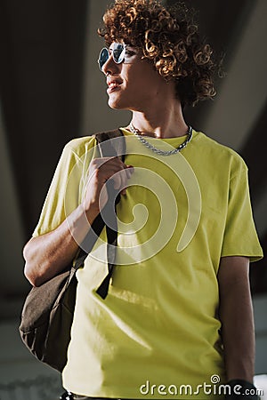 Gladsome person looking away wheil standing with backpack Stock Photo