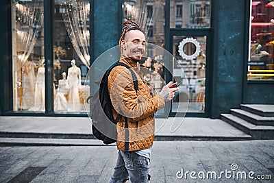Gladsome person using his modern gadget in the street Stock Photo