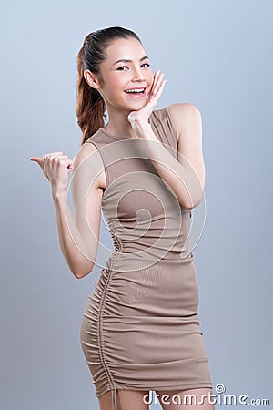 Glamorous beautiful asian woman making finger pointing in isolated background. Stock Photo