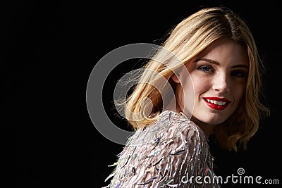 Glamorous blonde woman turning to camera, head shoulders Stock Photo