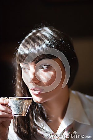 Glamorous brunette holding teacup Stock Photo